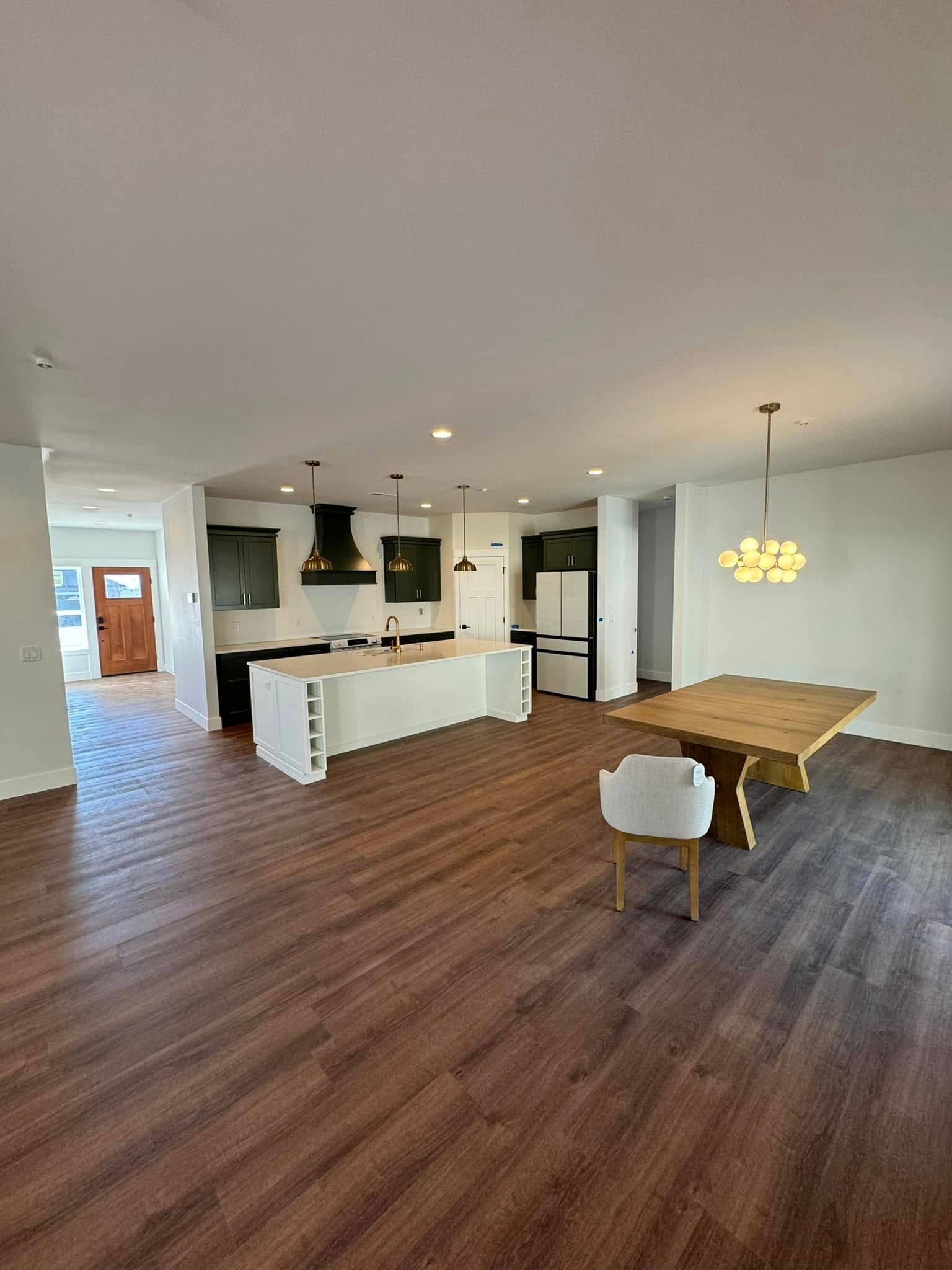 There is a table and chairs in the middle of the room.