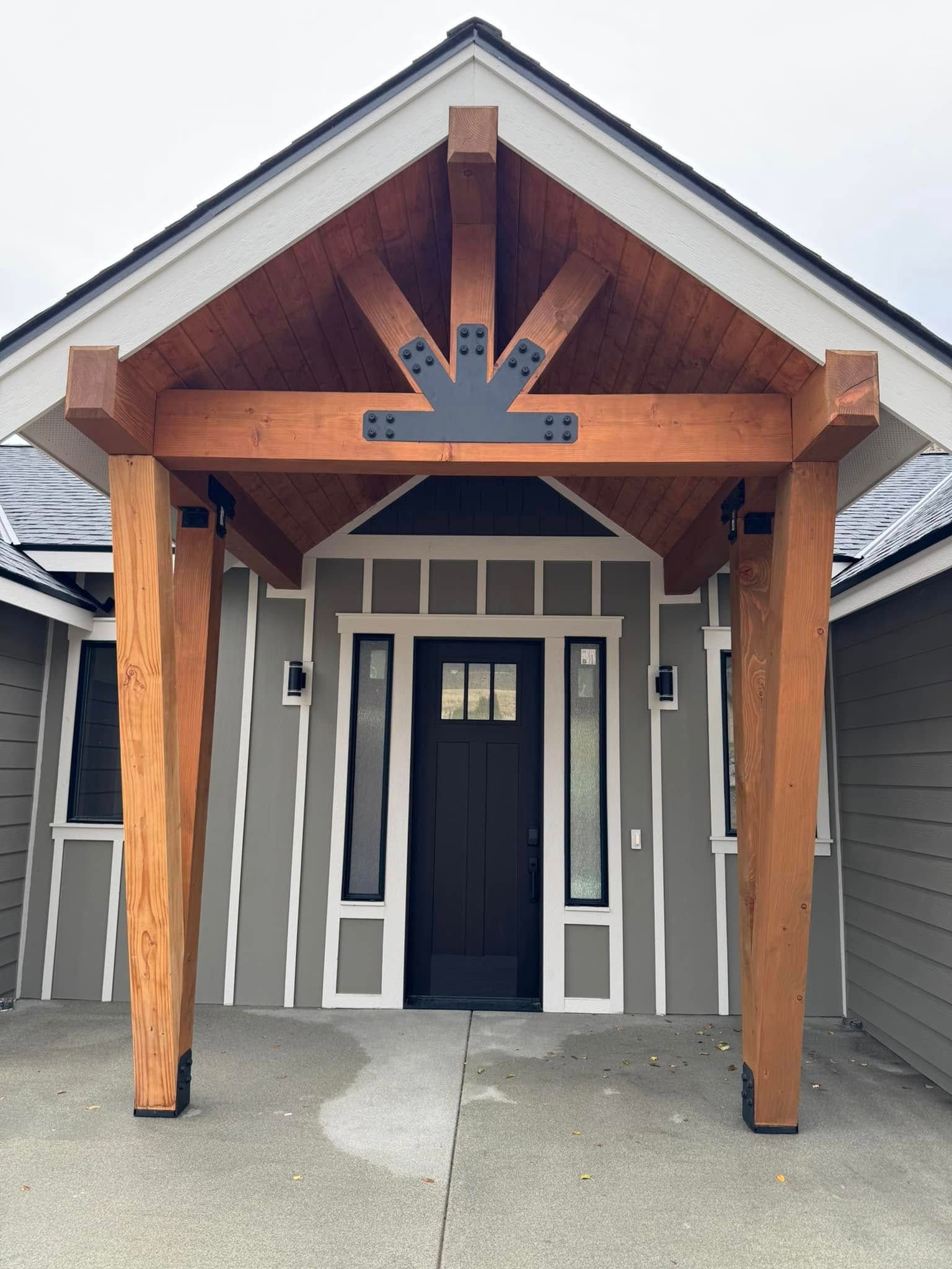A house with a wooden porch and a black door