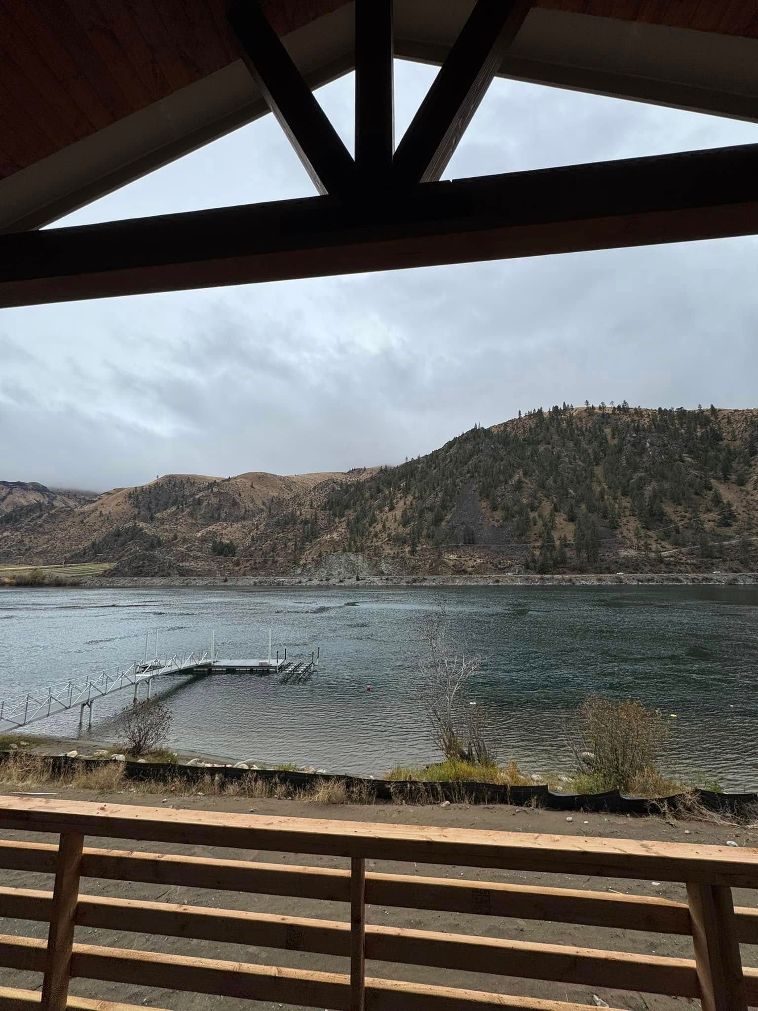 A view of a lake from a balcony with mountains in the background