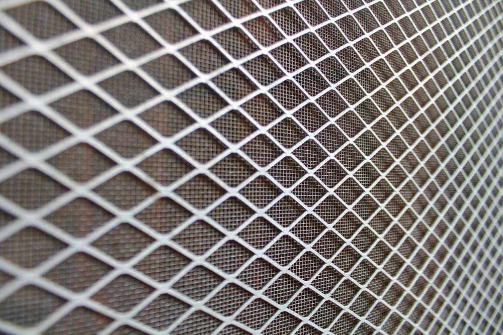 A Close Up of a Metal Mesh on a Wall — Budget Screens & Awnings in Byron Bay, NSW