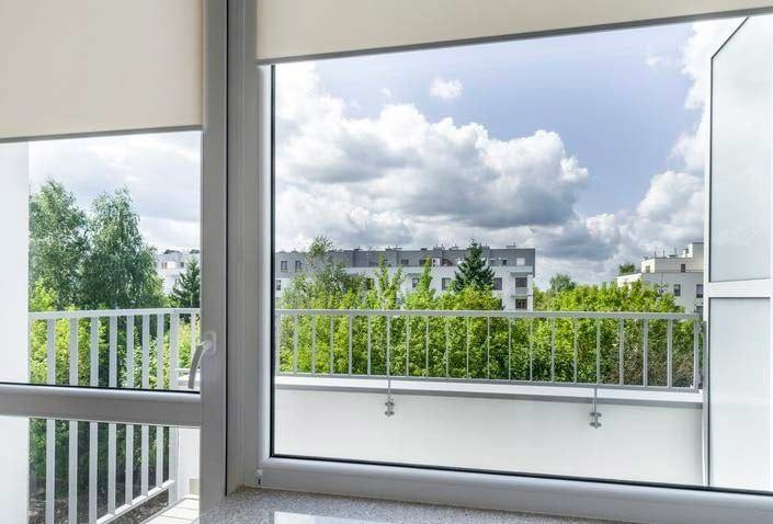 A Large Window With a View of a Balcony and Trees — Budget Screens & Awnings in South Lismore, NSW
