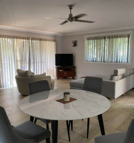 A Living Room With a Round Table and Chairs — Budget Screens & Awnings in South Lismore, NSW