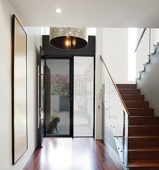 A Hallway With Stairs and a Glass Door — Budget Screens & Awnings in South Lismore, NSW