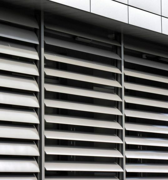 A Building With a Lot of Shutters on It — Budget Screens & Awnings in South Lismore, NSW 