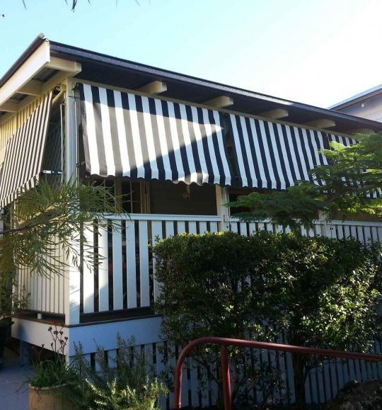 A House With a Black and White Striped Awning — Budget Screens & Awnings in South Lismore, NSW