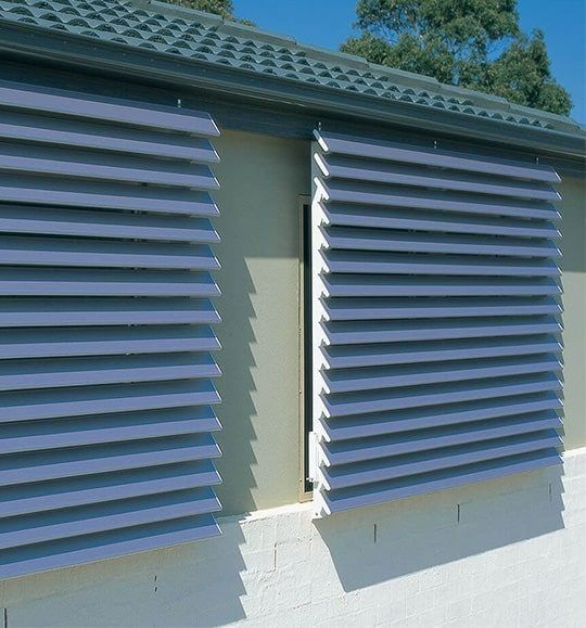 A Building With a Roof and a Window With Shutters on It — Budget Screens & Awnings in South Lismore, NSW