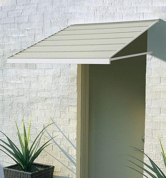 A Door With a Canopy Over It and a Potted Plant in Front of It — Budget Screens & Awnings in South Lismore, NSW