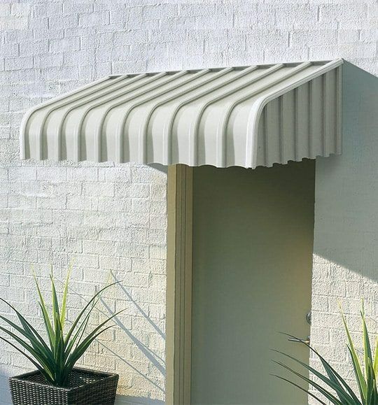 A White Awning Over a Door With Two Potted Plants in Front of It — Budget Screens & Awnings in South Lismore, NSW