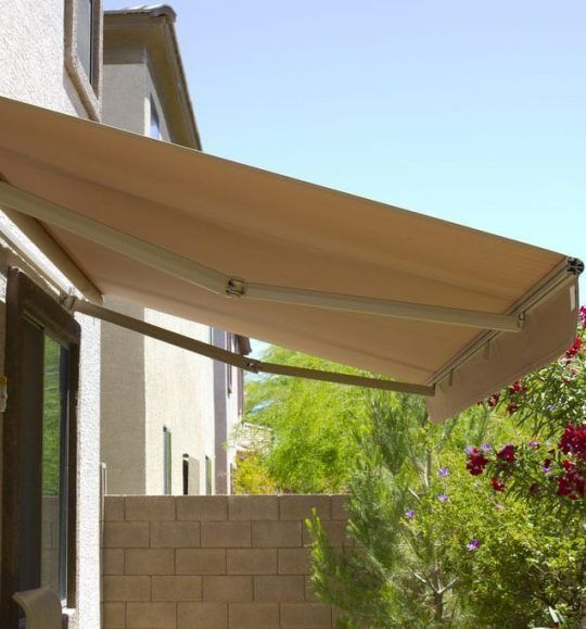 A Tan Awning is Hanging From the Side of a House — Budget Screens & Awnings in South Lismore, NSW