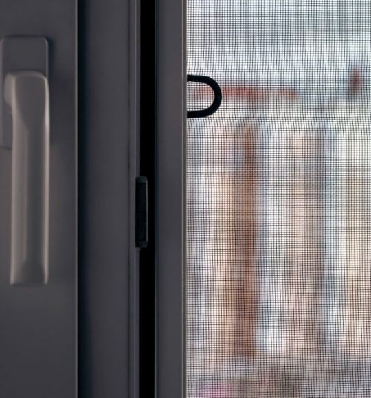 A Close Up of a Screen Door With a Handle — Budget Screens & Awnings in South Lismore, NSW