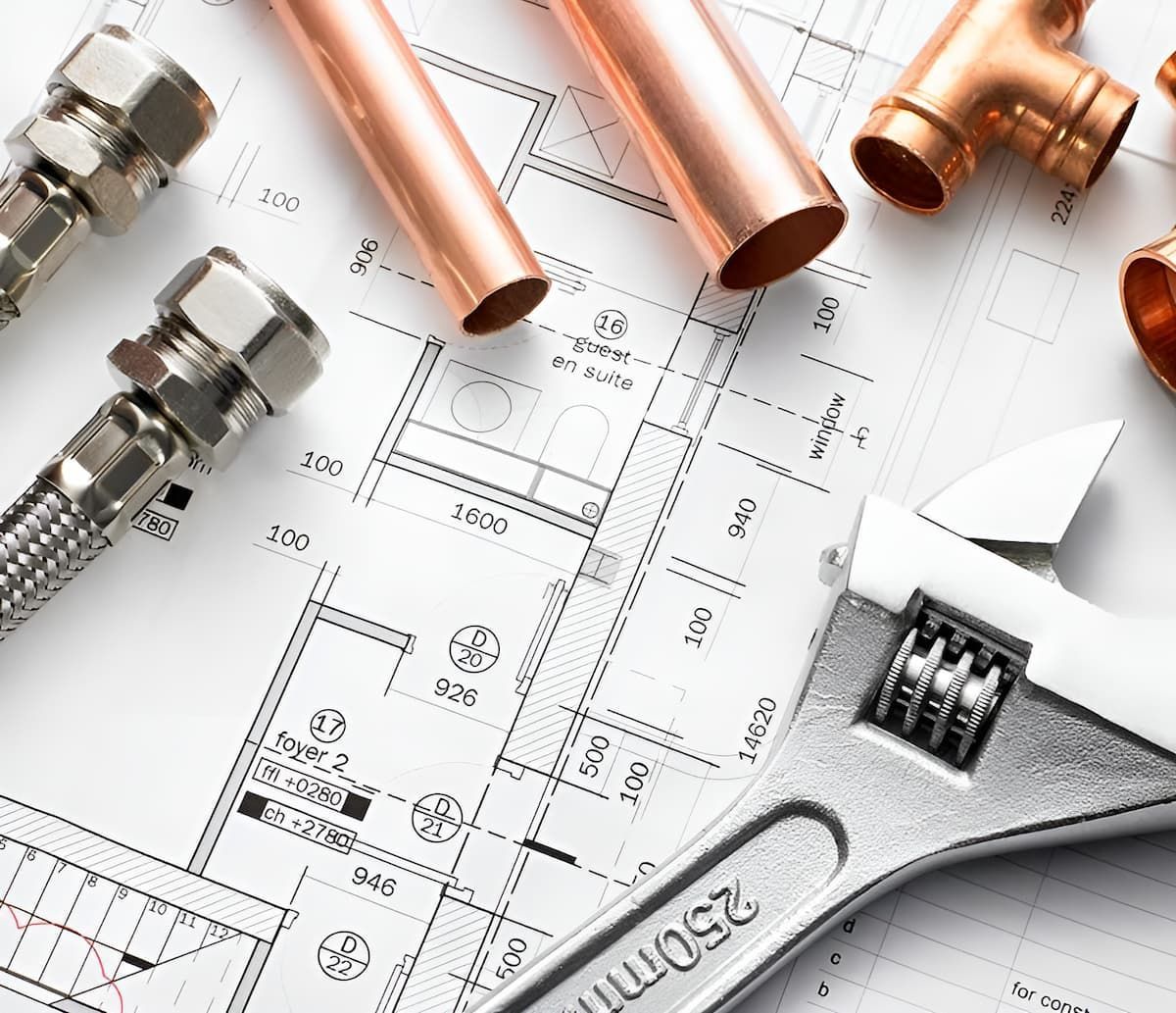Copper Pipes And A Wrench On Top Of A Blueprint — Shannon Malone Plumbing In Gerringong, NSW