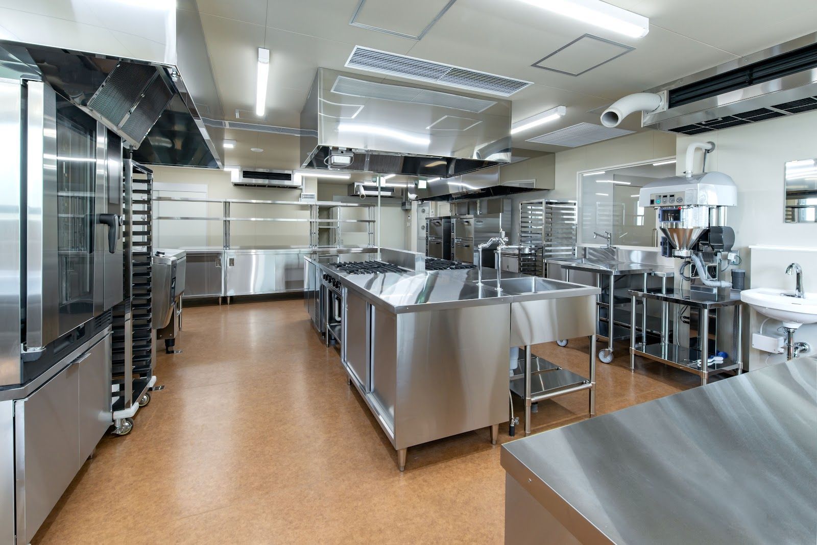 Commercial kitchen with stainless steel appliances and equipment.