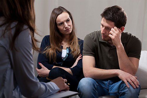 counselor sitting across from couple at therapy