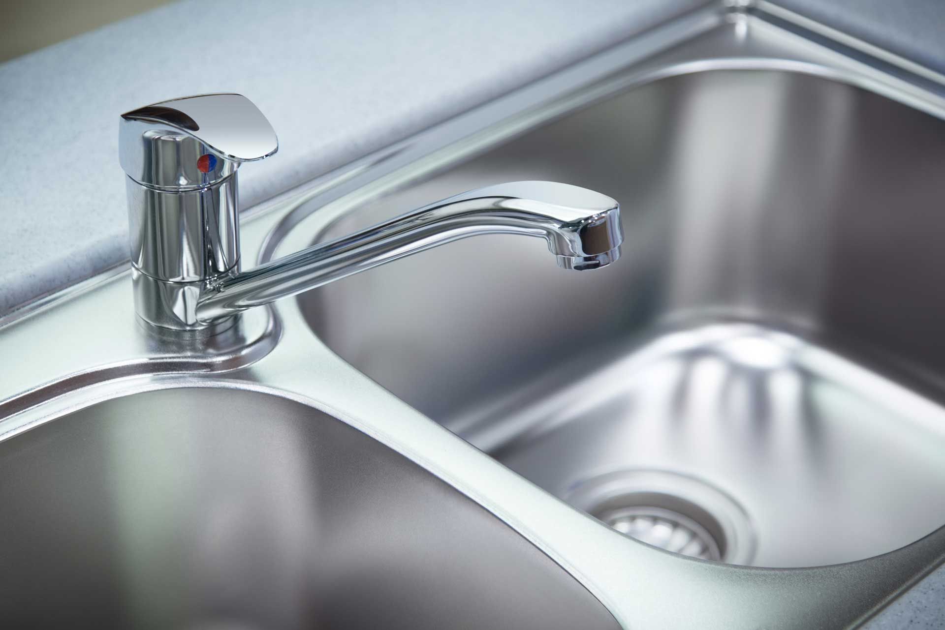 Silver kitchen sink with a chrome faucet.
