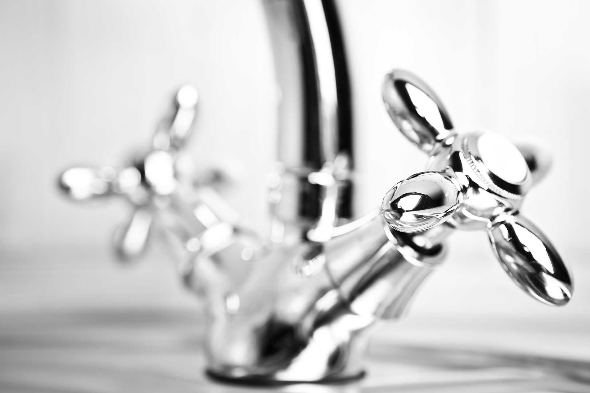 Chrome faucet with two cross-shaped handles.