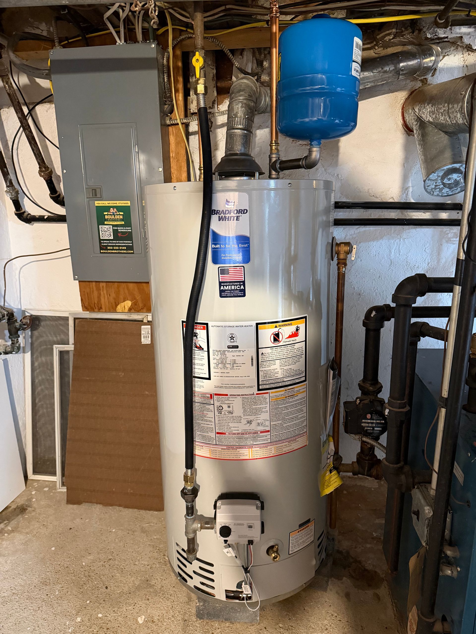 Plumber working on a chrome faucet with pliers near a bathroom sink.