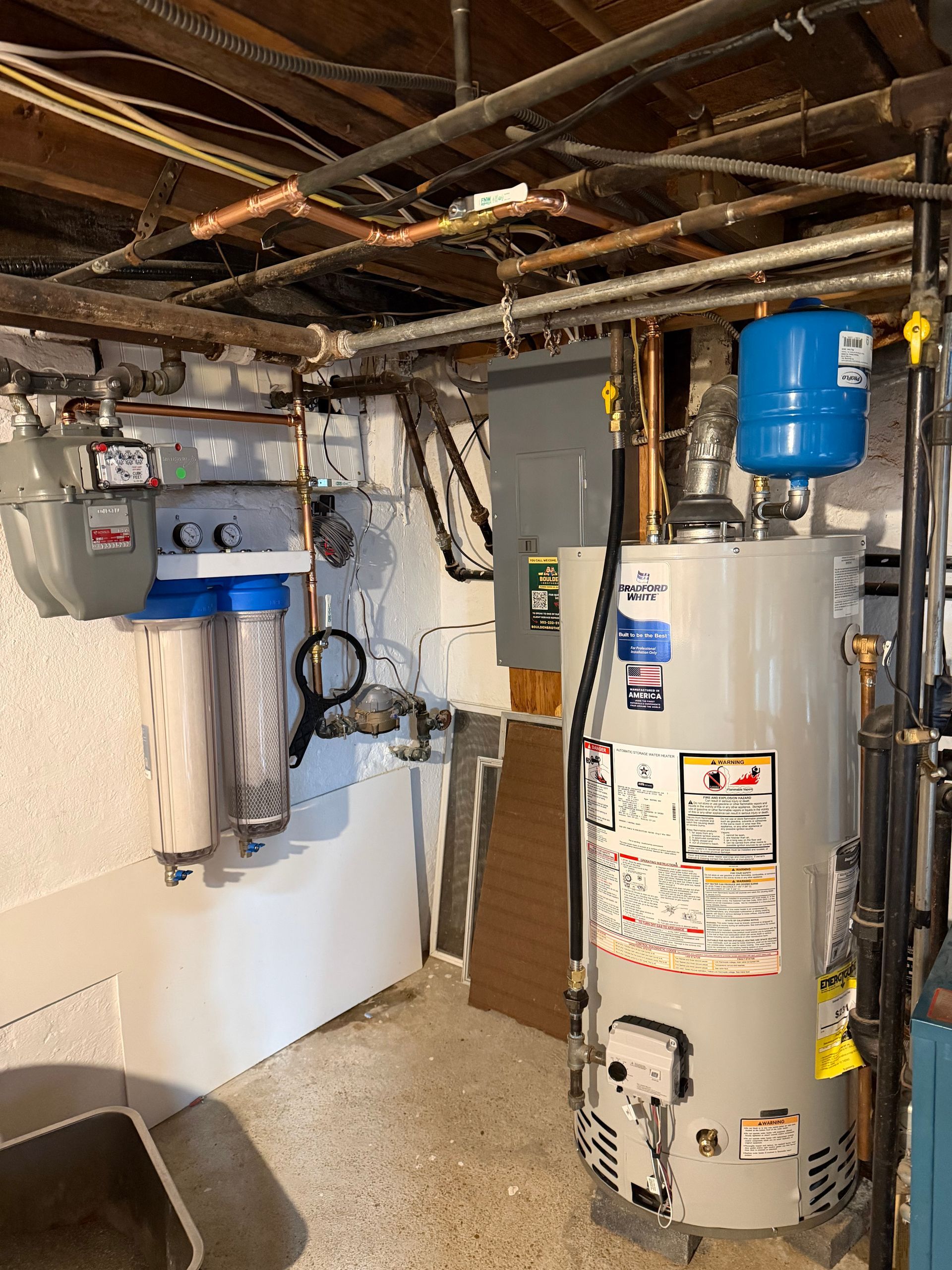 Black bathroom vanity with white countertop and black faucet against a white wall.