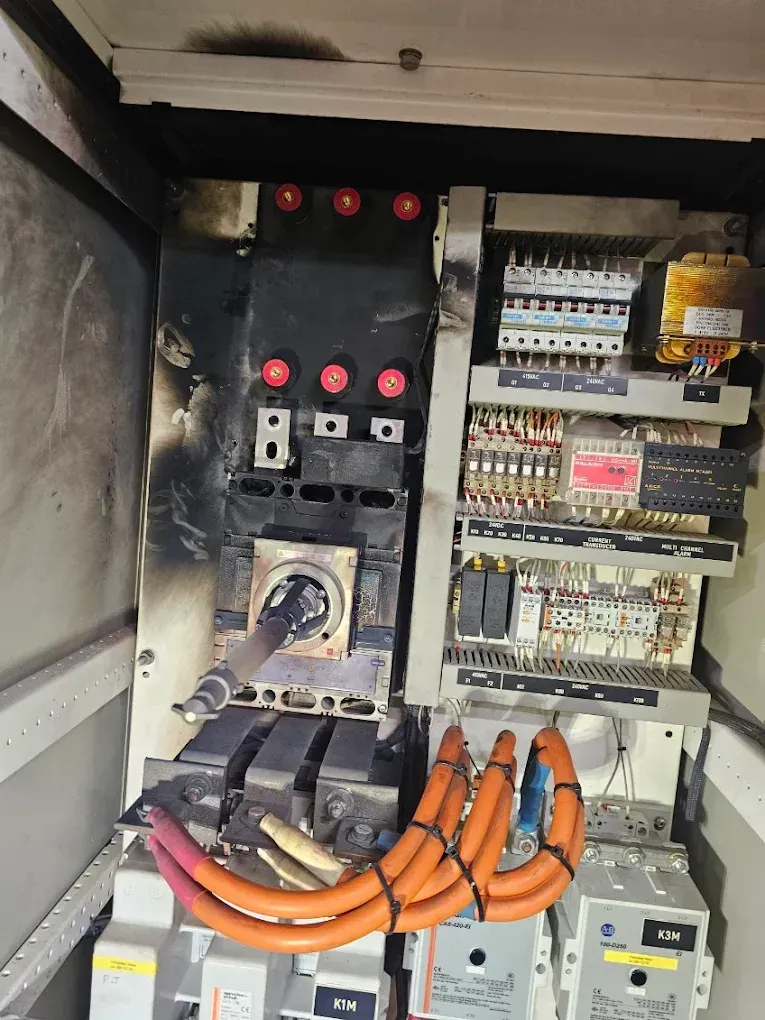 Two Workers in Safety Gear Repairing Machinery — Projected Contracting Electrical Services In Tablelands, QLD