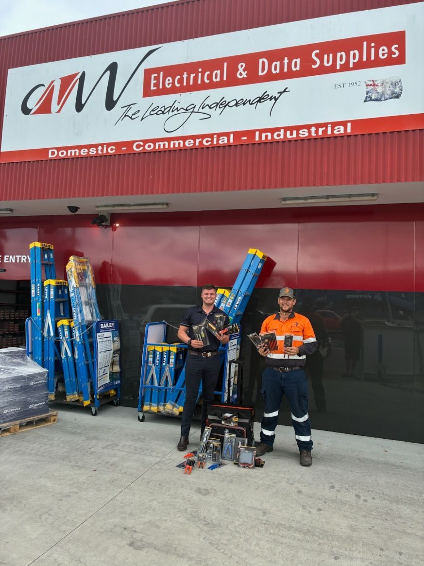 Two Men Pose Outside an Electrical Supply Store — Projected Contracting Electrical Services In Portsmith, QLD