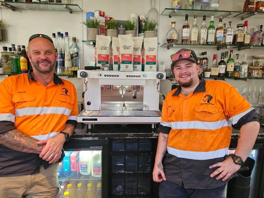 A Person Operating an Espresso Machine — Projected Contracting Electrical Services In Portsmith, QLD