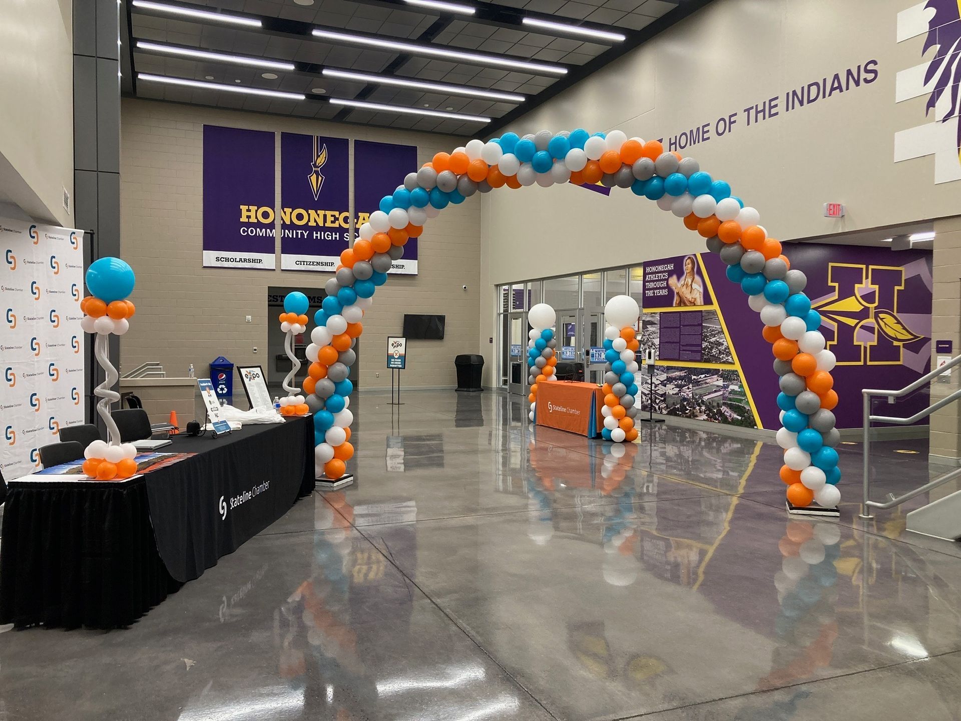 A large room with balloons and a sign that says one of the indians
