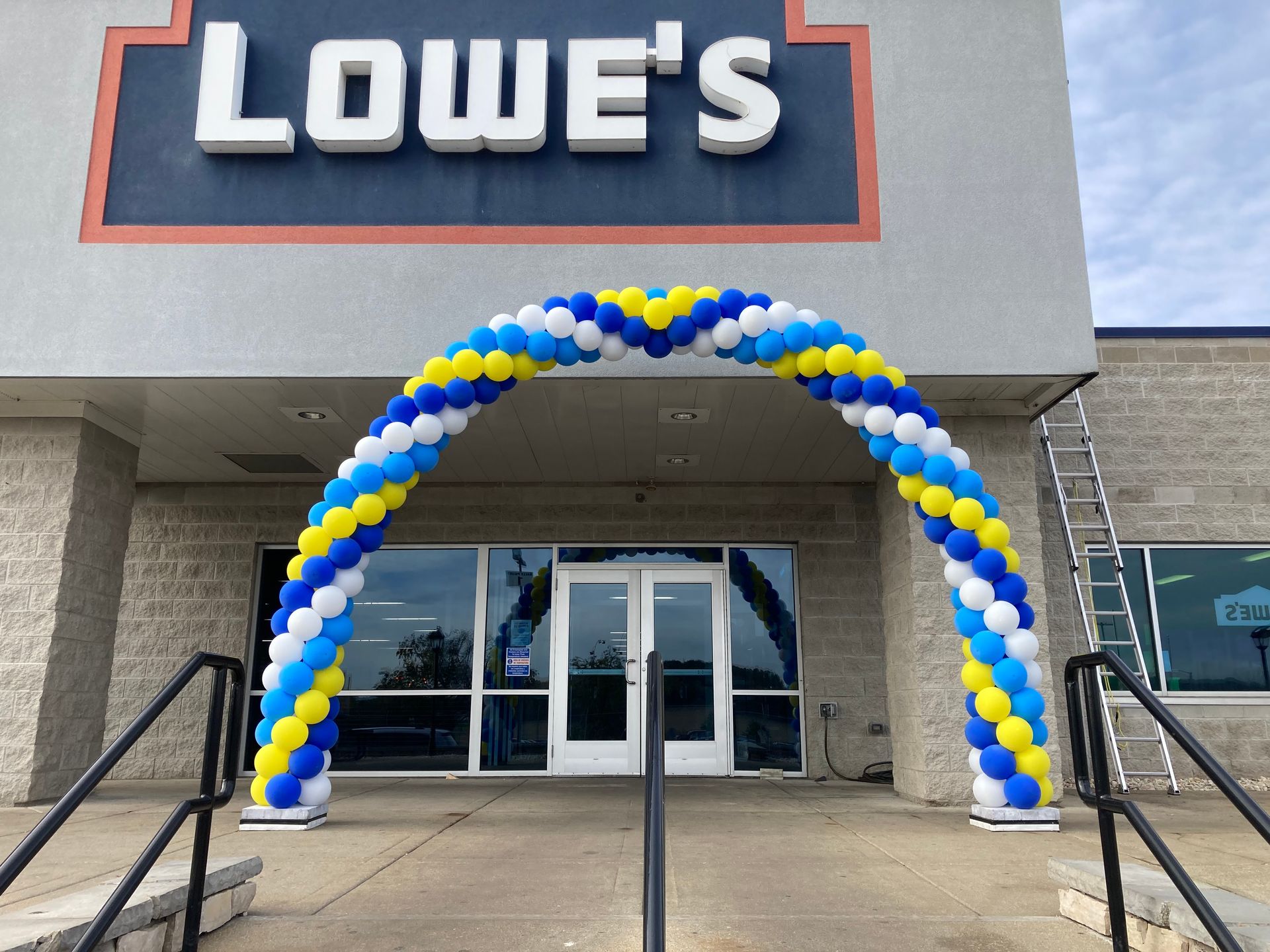 A lowe 's store with a balloon arch in front of it