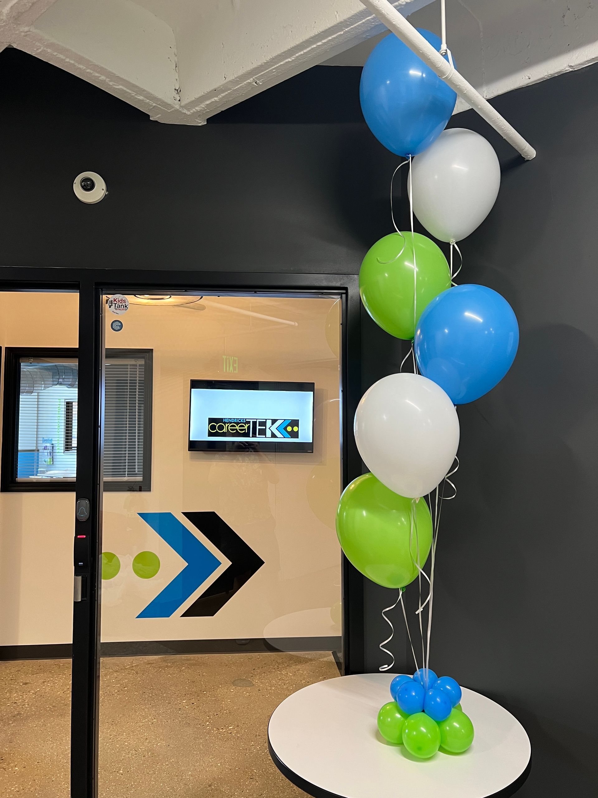 A bunch of balloons are hanging from the ceiling in a room