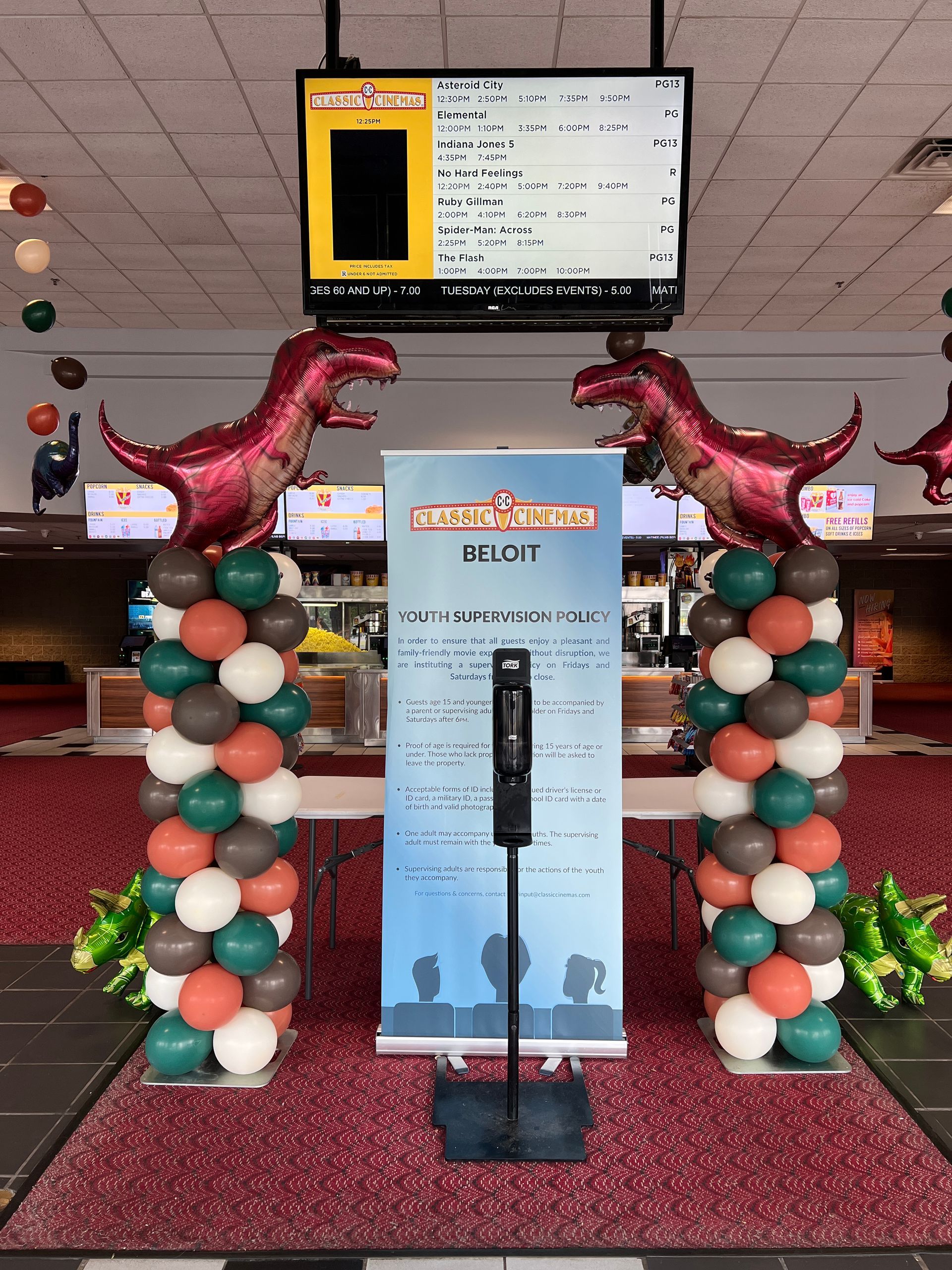 A podium with balloons and a sign that says show