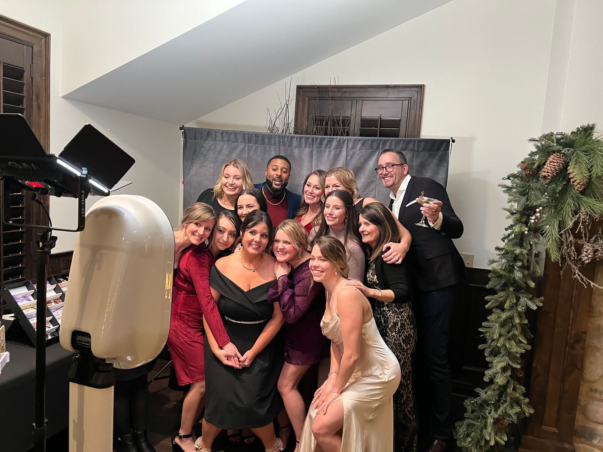 A group of people are posing for a picture in front of a photo booth.