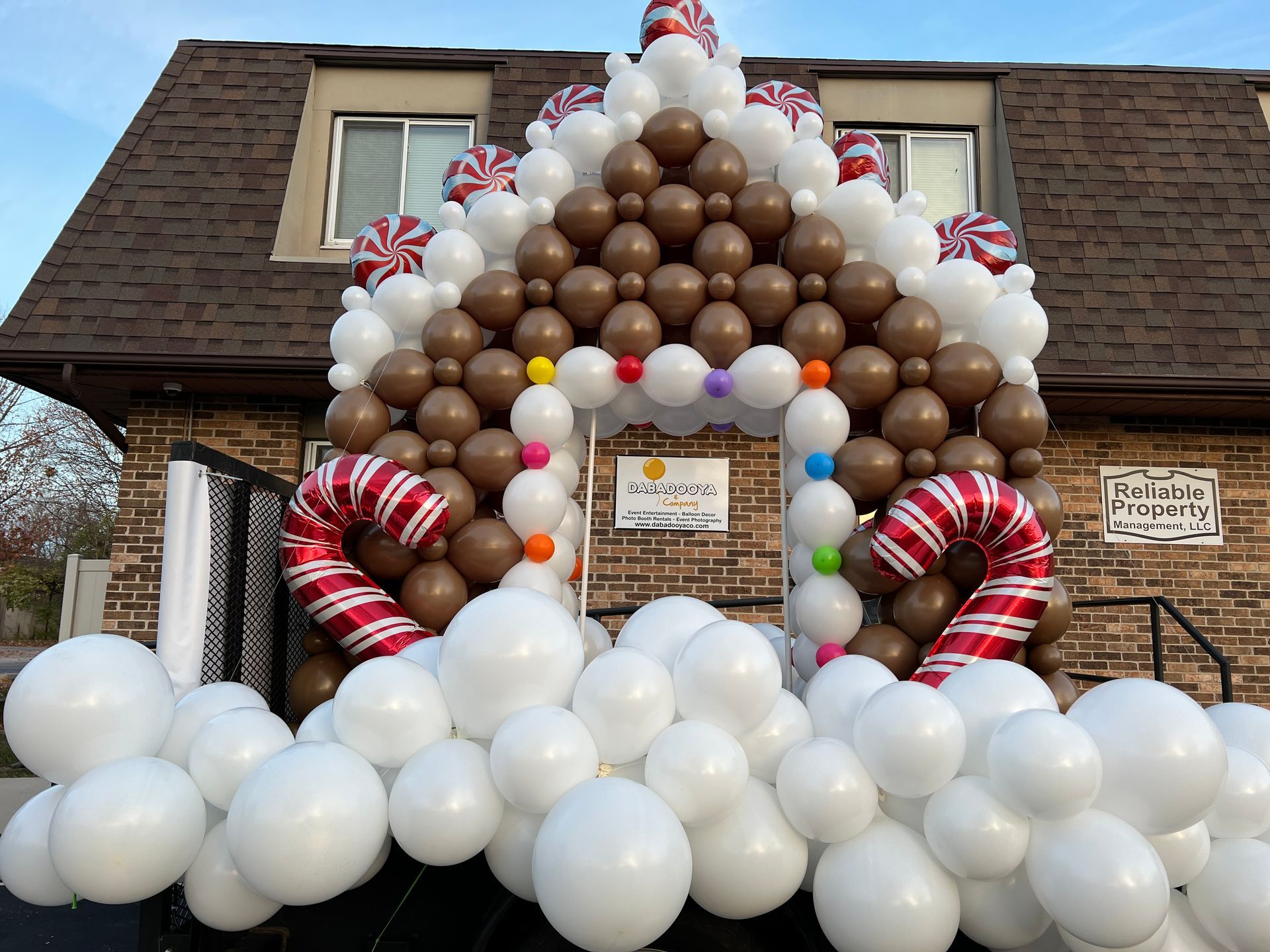 A gingerbread house made out of balloons and candy canes