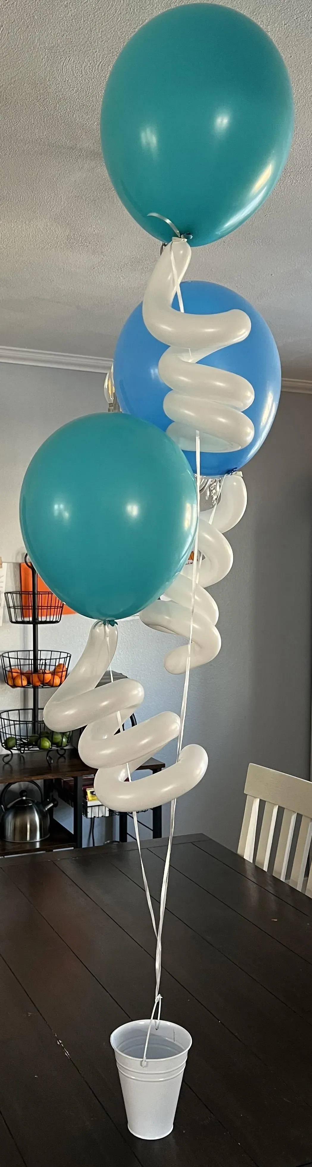 A bunch of balloons sitting on top of a table.