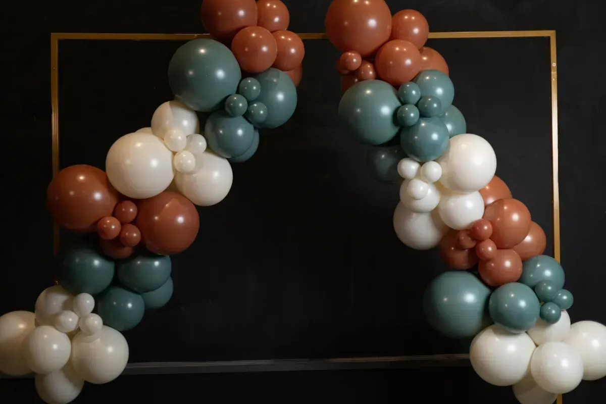 A bunch of balloons are sitting on top of each other on a table.