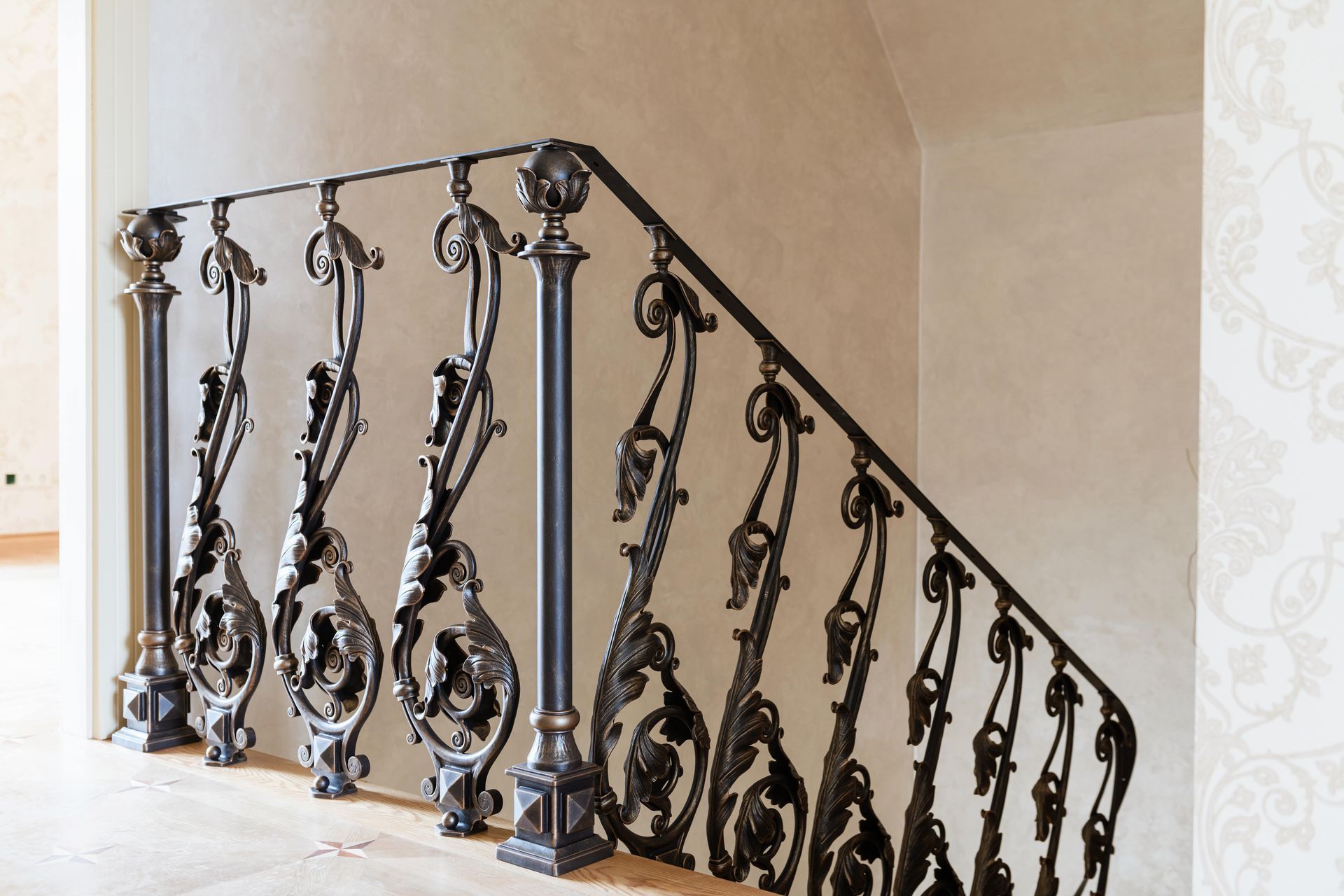 ornate iron railing at top of stairs inside luxury home