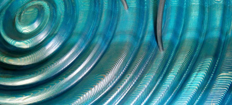 A close up of a blue surface with a circular pattern.