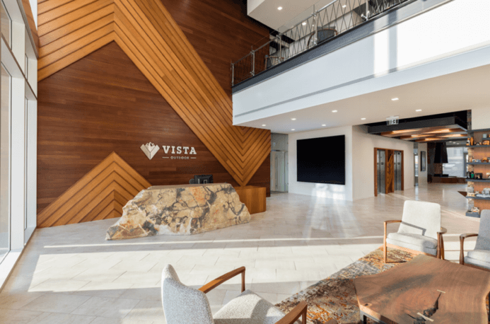 A lobby with a wooden wall and a sign that says vista