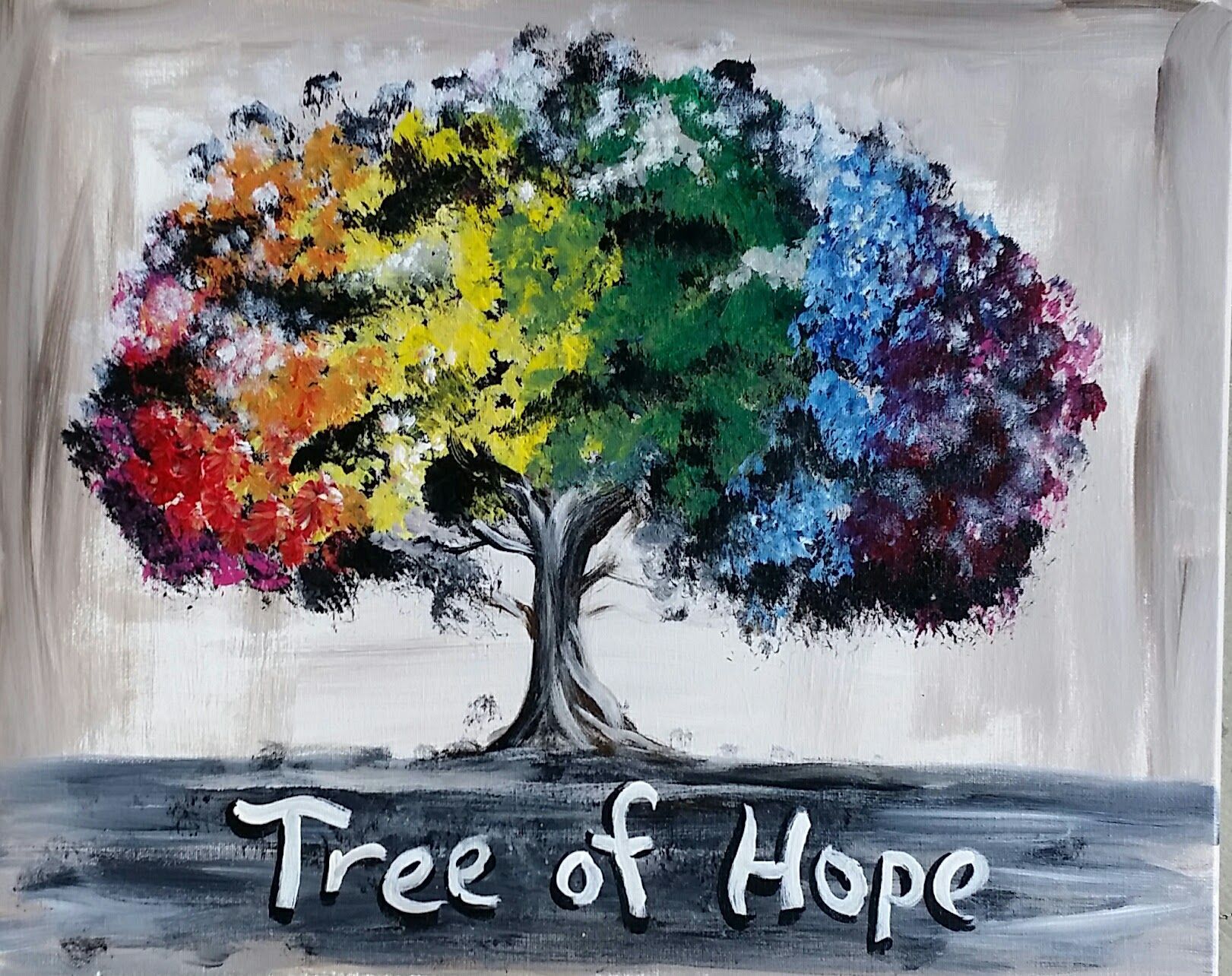 Colorful tree with rainbow leaves, painted on a canvas. Caption reads