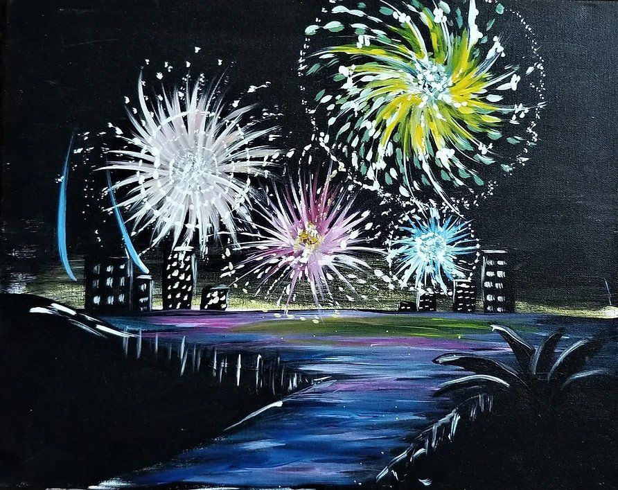 Fireworks over a city skyline at night. Colorful explosions reflect on a body of water.