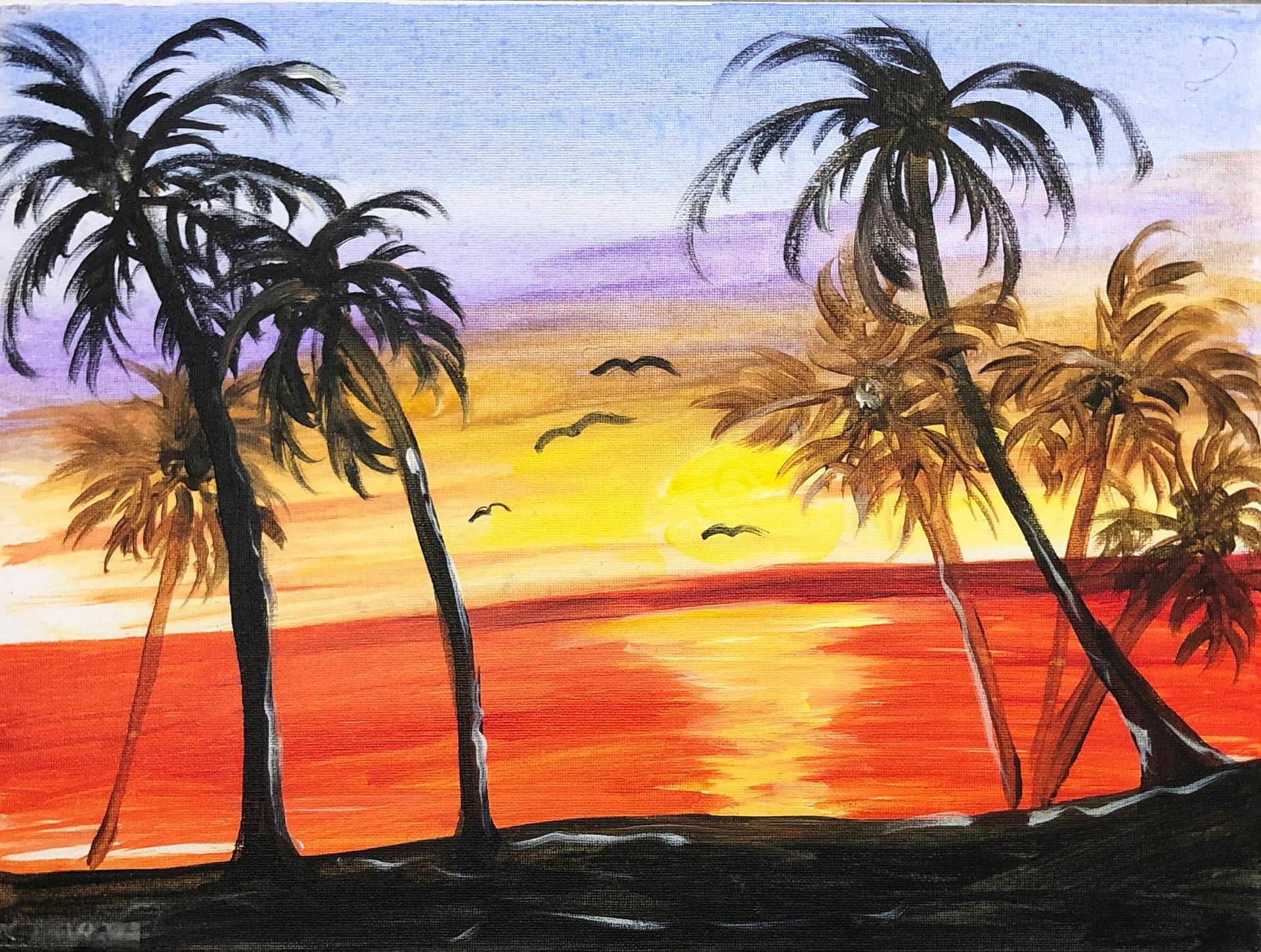 Sunset over ocean with palm trees silhouetted against red, orange, and purple sky.