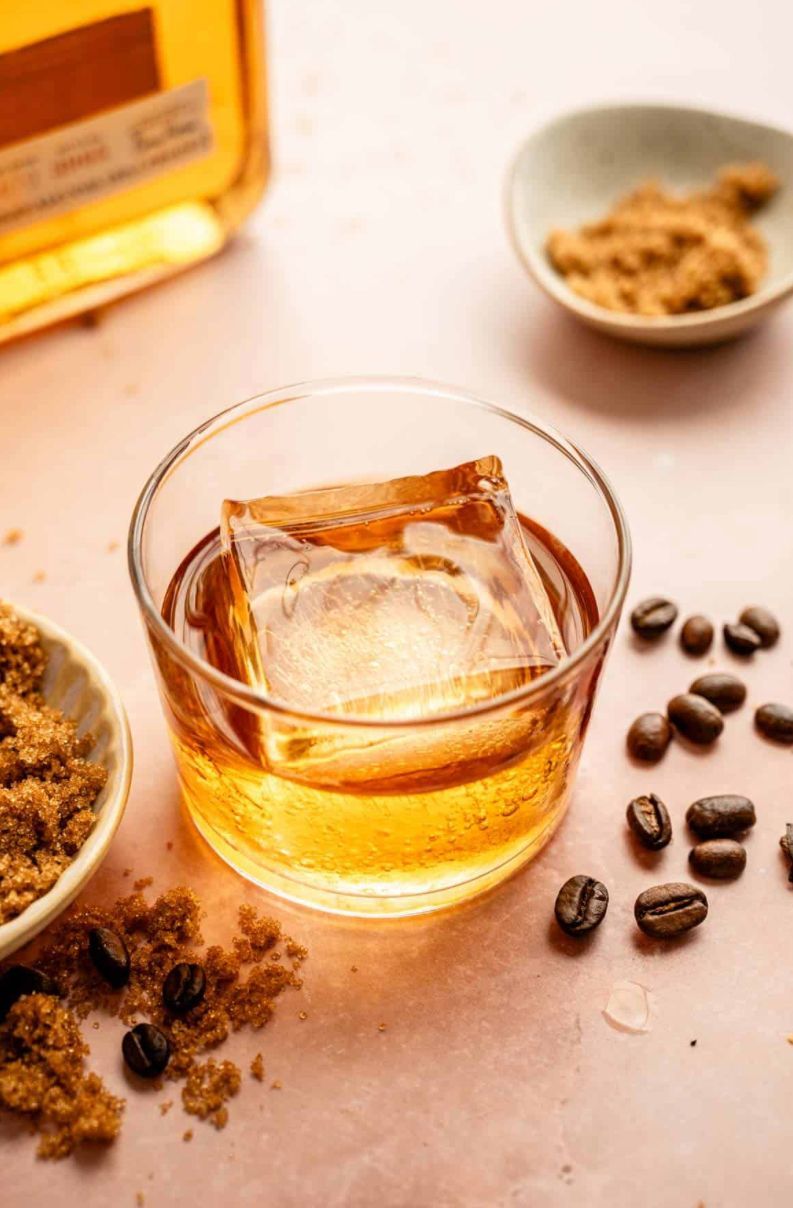 Three champagne glasses filled with ice are sitting on a bar.