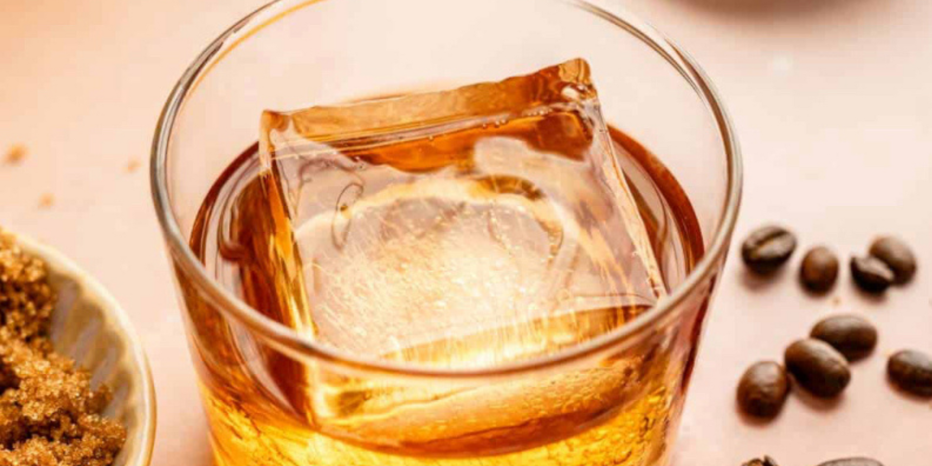 Three champagne glasses filled with ice are sitting on a bar.