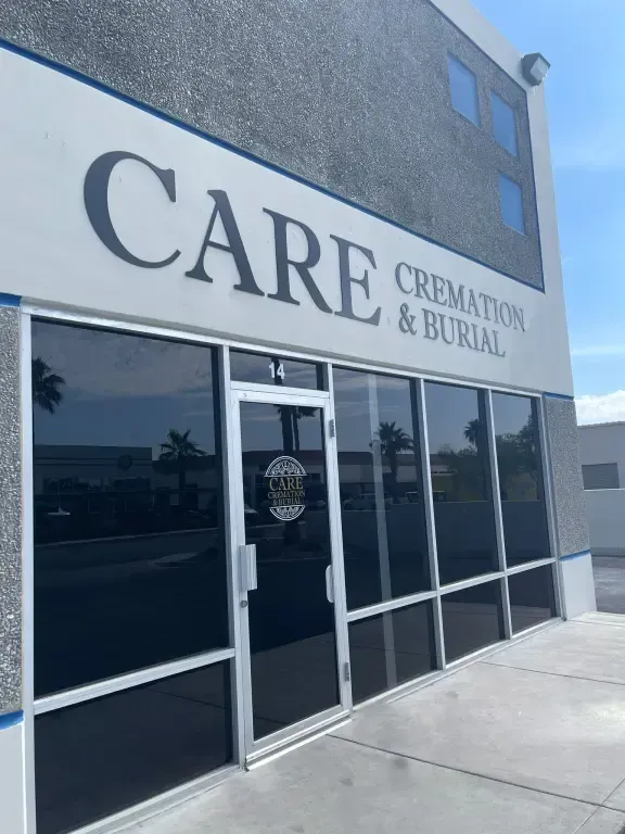 Care Crematory & Burial storefront with glass doors and blue stucco exterior