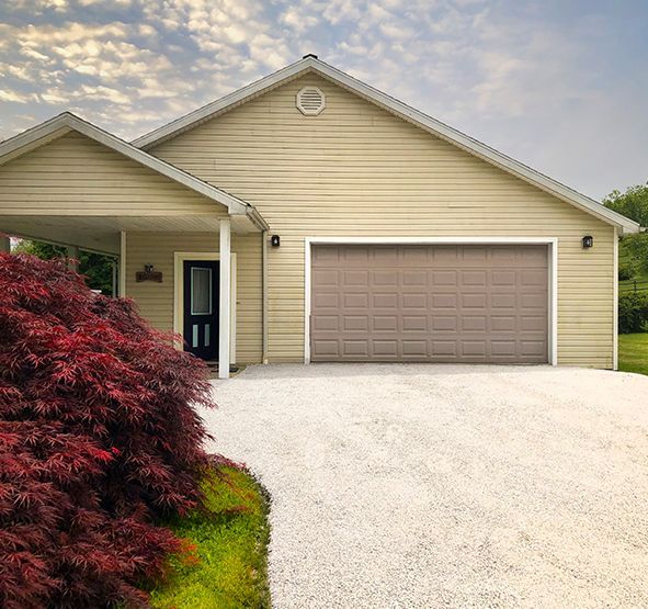 a house with a garage door and a driveway