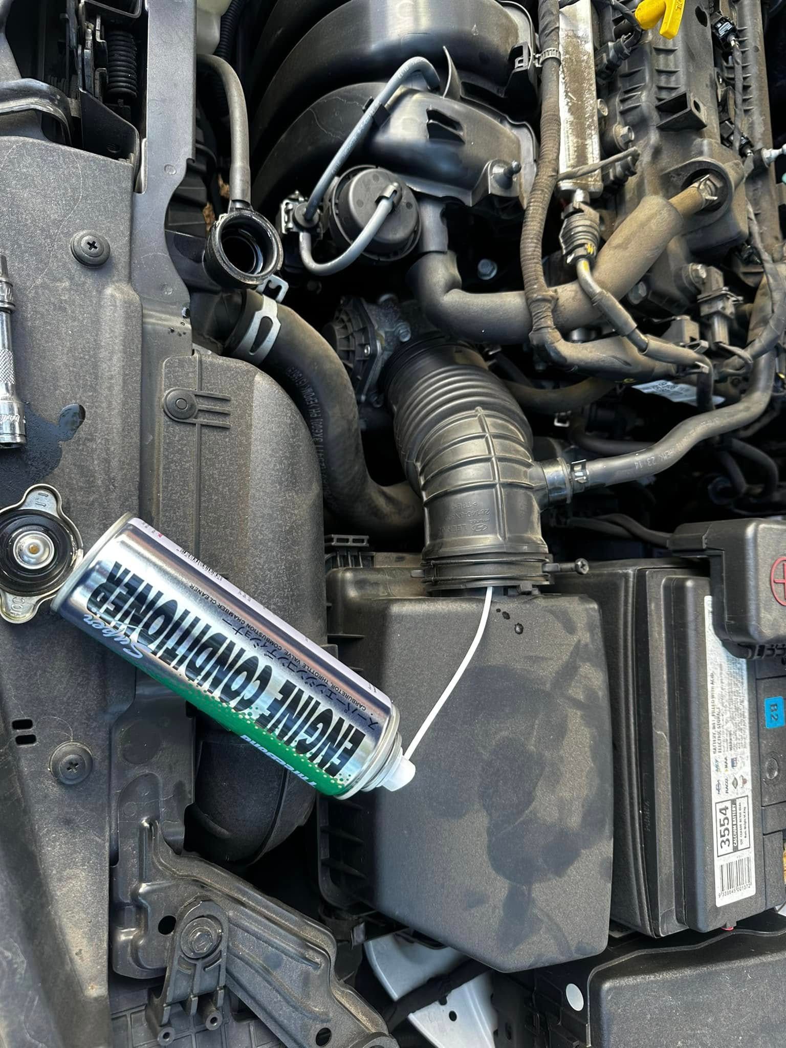 A can of air conditioner cleaner is being used to clean a car's engine. — JDM Mobile Mechanical in Fairfield, NSW