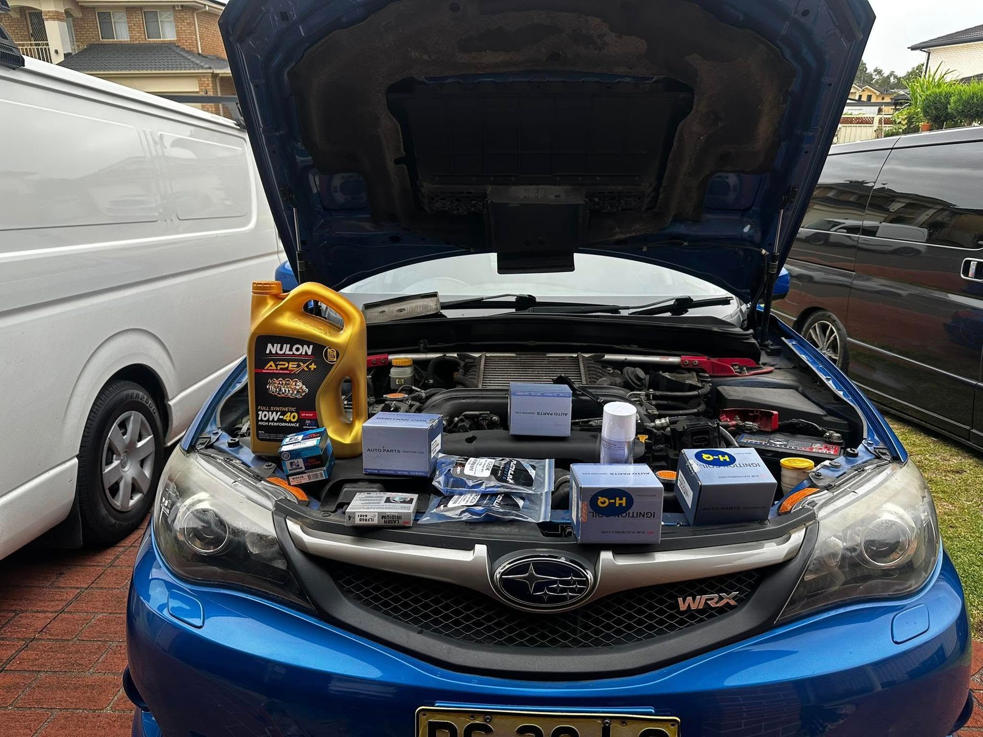 Blue Subaru With Open Hood Displaying Car Parts, Oil, and Filters — JDM Mobile Mechanical in Holsworthy, NSW