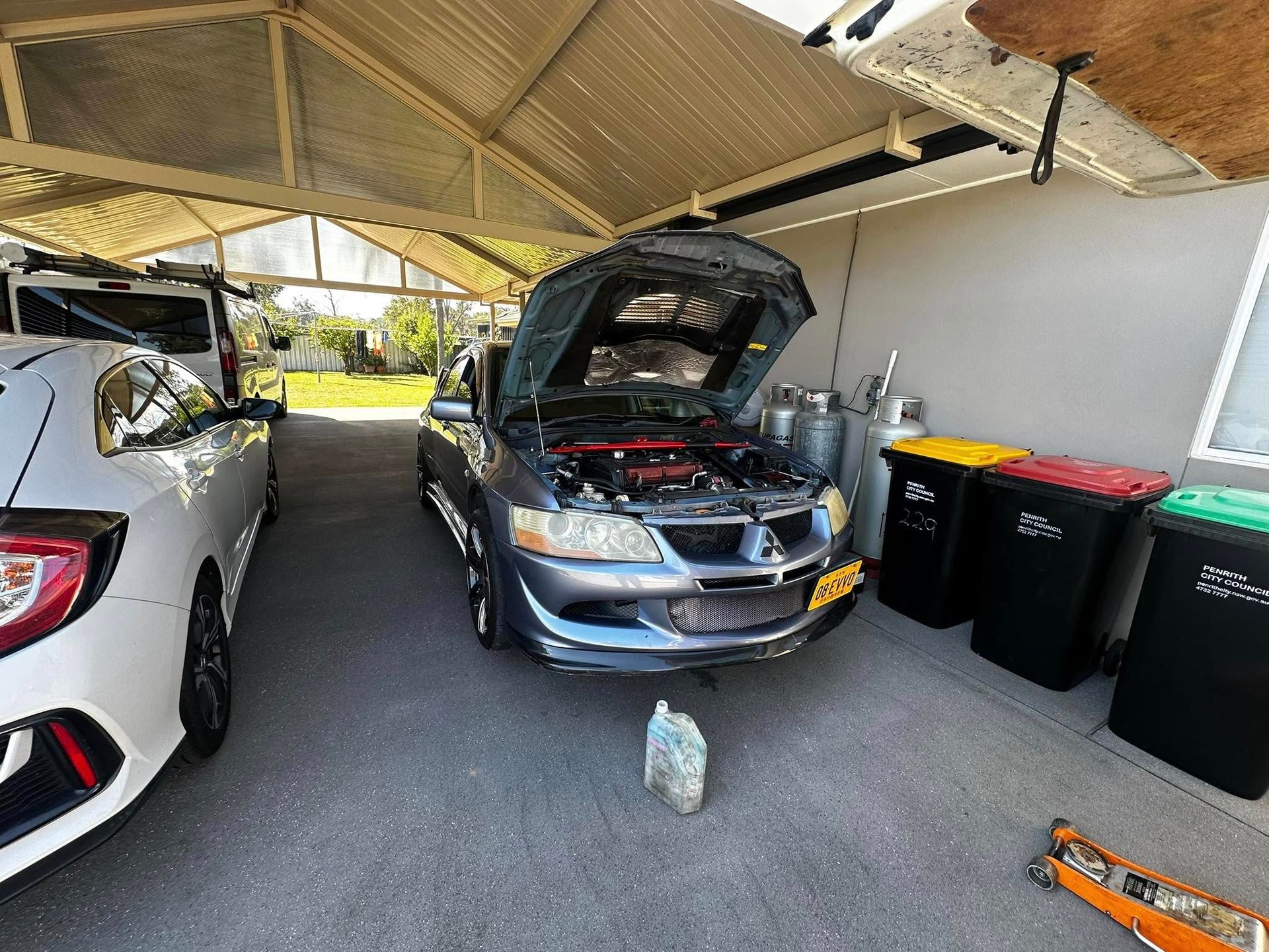 Gray Car With Open Hood Under a Carport — JDM Mobile Mechanical in Fairfield, NSW