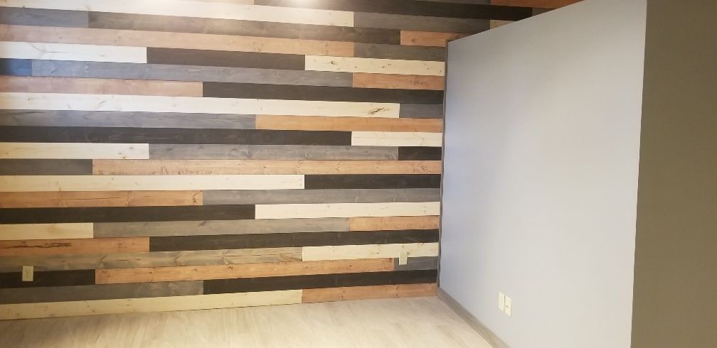 Wooden plank wall with light gray and tan tones and a light gray wall on the right.
