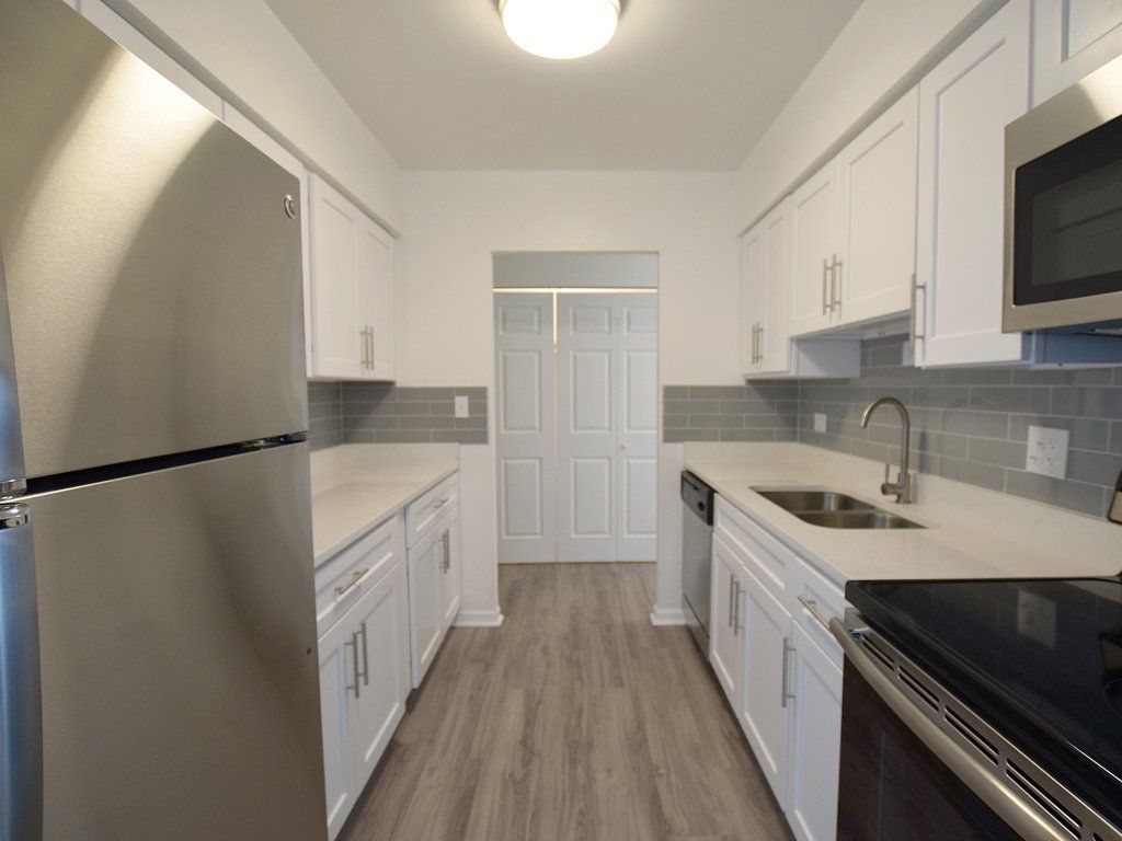 Kitchen with white cabinetry and stainless steel appliances