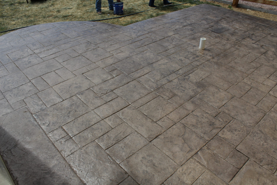 Ashlar slate stamped concrete patio with a natural stone look, ideal for enhancing outdoor spaces with elegance.