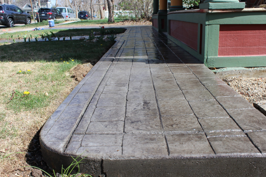 Cobblestone stamped concrete path with a rustic finish, perfect for adding charm to residential landscapes.