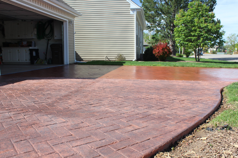 Brick-pattern stamped concrete driveway offering a stylish and durable surface for residential exter